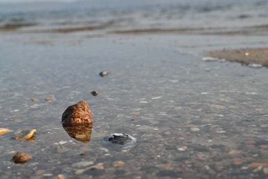 Rocky Shoreline with Clear Water Reflection photo