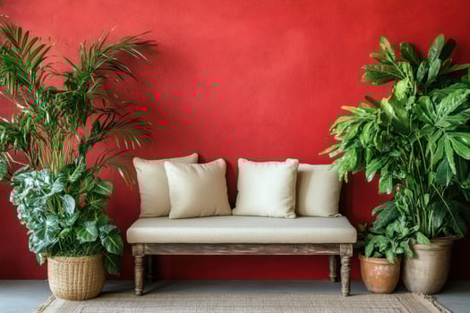 red wall with potted plants and a bench photo