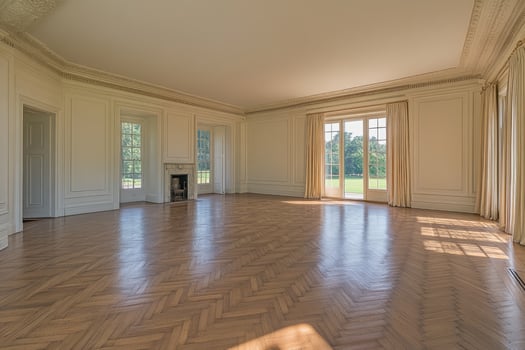 Spacious, sun-drenched interior with parquet floor photo