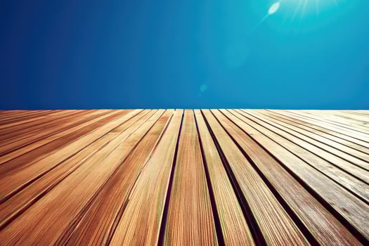 Wooden decking under a vibrant blue sky photo