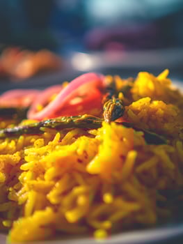 Close up of Turmeric Rice with Roasted Asparagus and Red Onion. A vibrant and appetizing image perfect for food blogs, magazines, and culinary websites. photo