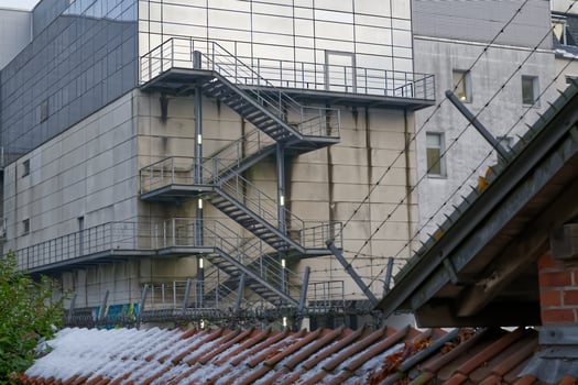 Modern Building with Fire Escape and Snowy Roof photo