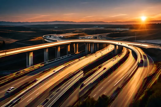 A highway with cars driving on it at sunset photo