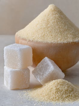 Close up of Granulated Sugar and Sugar Cubes in a Wooden Bowl. photo