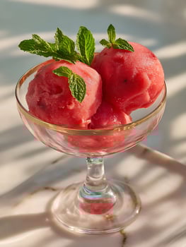 Refreshing Red Sorbet in a Glass Bowl, Garnished with Mint. photo