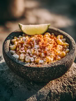 Delicious Esquites in a Molcajete Bowl A Close Up of Mexican Street Corn. photo