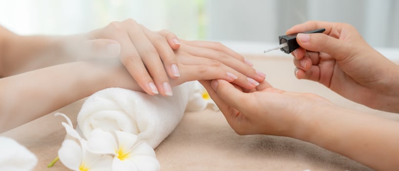 Woman receive care service by professional Beautician Manicure at spa centre. Nail beauty salon use nail file for Glazing treatment. manicurist make nail customer . photo
