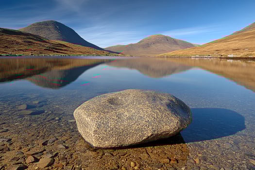 Tranquil mountain lake reflecting peaks photo
