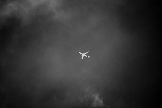 Airplane in a cloudy monochrome sky photo