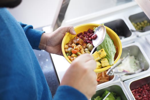 Healthy meal preparation at a cafeteria buffet line photo