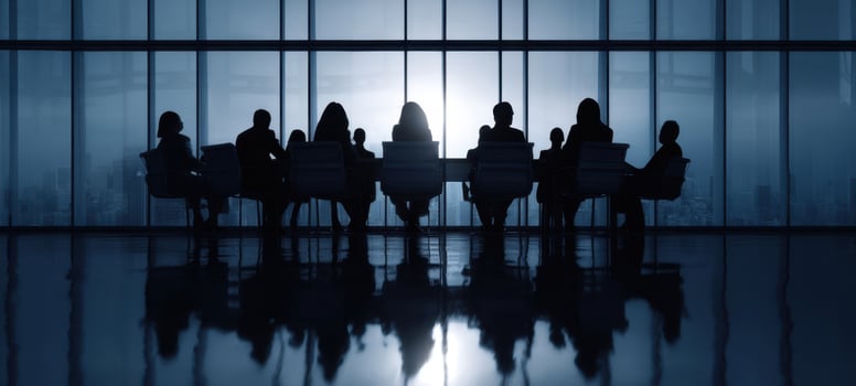 The silhouettes of professionals engaged in a strategic business meeting. photo