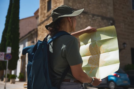 Explorer Navigating a Historic Spanish Village with a Map Outdoors photo