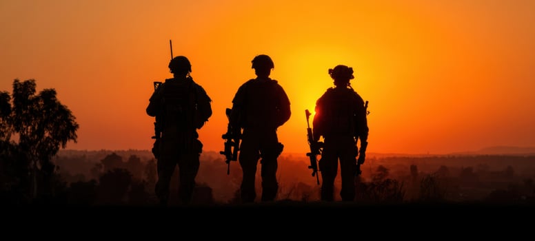 The soldiers standing united against a dramatic sunset backdrop. photo
