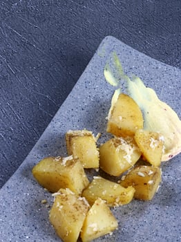 Spiced potatoes garnished with coconut flakes photo