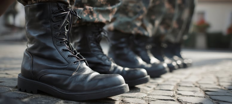 The soldier's boots lined up in formation on a cobblestone street. photo