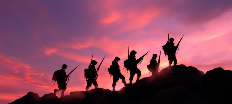 The silhouettes of soldiers against a vibrant sunset sky. photo