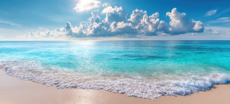 The serene ocean waves gently lap against the sandy beach under a blue sky. photo