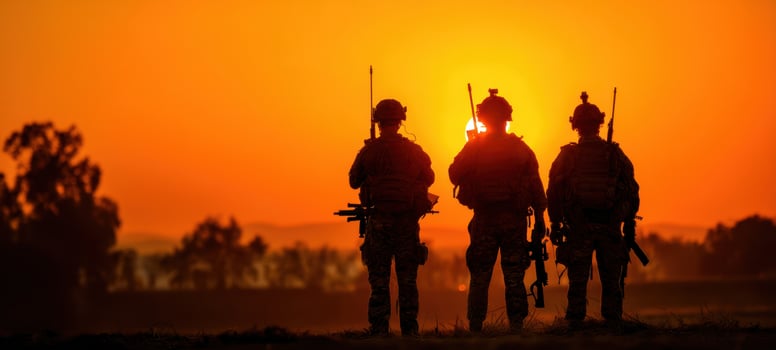 The soldiers standing together against a stunning sunset backdrop. photo