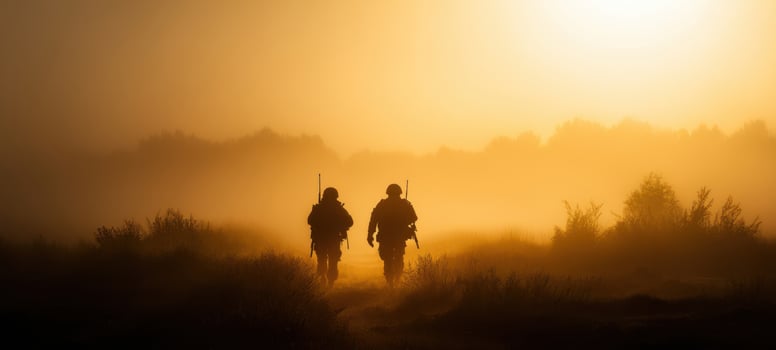 The soldiers walking through fog at sunrise in a tranquil landscape. photo