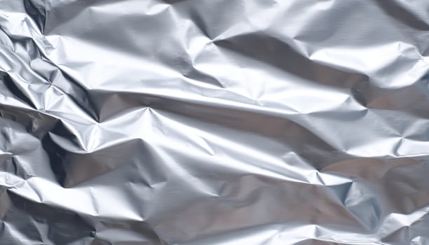 Wrinkled aluminum foil texture reflecting light close-up photography studio abstract photo