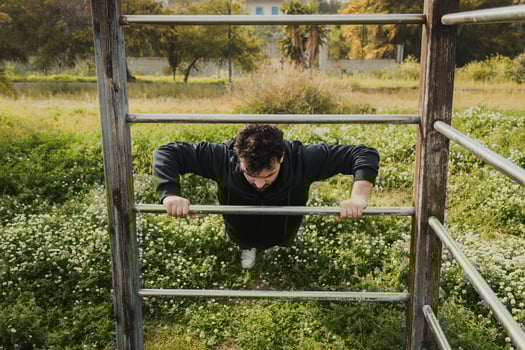 Man Works Out in Spring Outdoors Doing Push Ups Sport Exercise photo