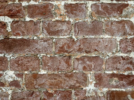 Distressed red brick, old rough brick wall. Horizontal brick wall texture with aged plaster. photo