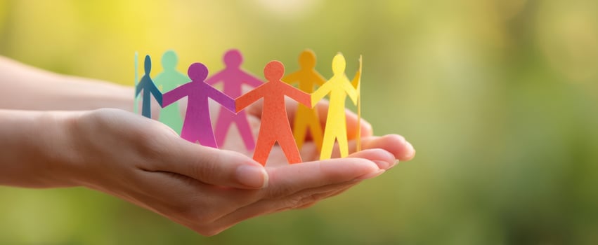 The vibrant paper figures representing unity and collaboration in hands. photo