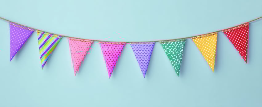 The festive bunting decoration in vibrant colors against a blue background. photo