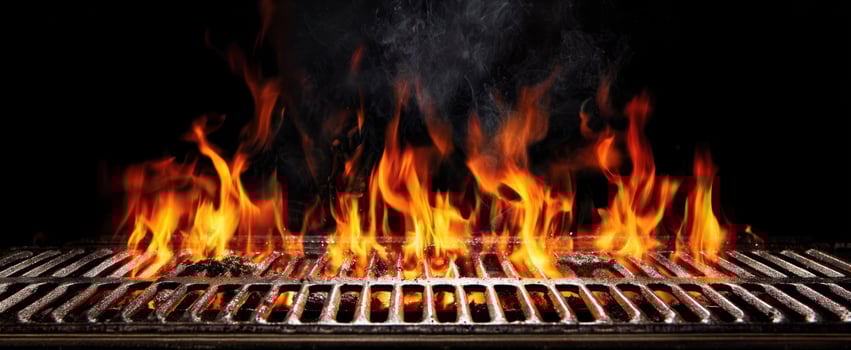 The vibrant flames dancing on the grill creating a mouthwatering cooking experience. photo