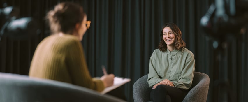 The smiling woman engaged in a thoughtful interview setting. photo