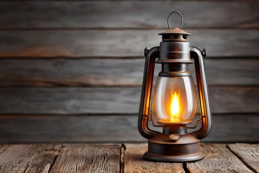 Burning oil lamp illuminating rustic wooden table photo