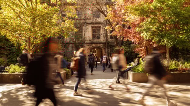The vibrant campus scene showcasing students walking through an autumn landscape. photo