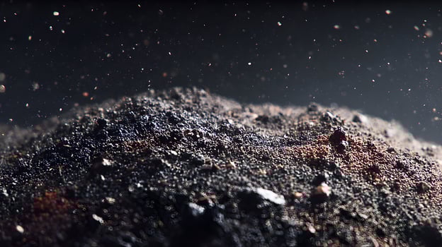 Abstract dark texture with scattered particles evoking a sense of cosmic dust and granular matter photo
