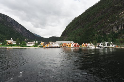 Mo, Norway - July 11, 2024. Colorful waterfront houses and church in Norwegian fjord village photo