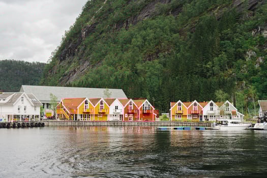 Mo, Norway - July 11, 2024 - Colorful waterfront houses and church in Norwegian fjord village photo
