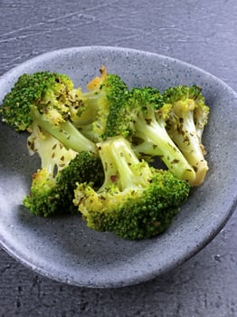 Steamed broccoli in a gray bowl photo