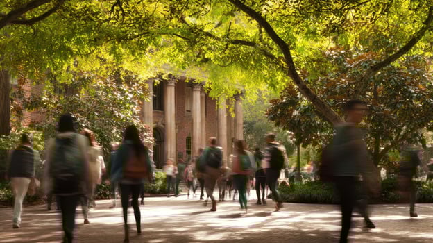 The busy campus scene with students walking under vibrant trees photo