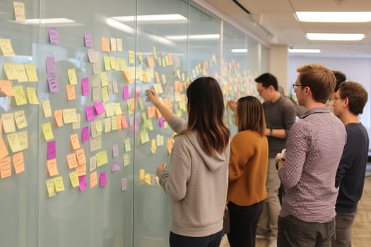 Team collaborates on brainstorming session with sticky notes in modern office environment photo