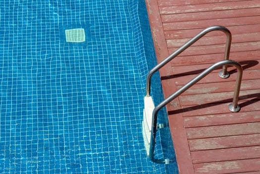 Metal ladder entrance to the swimming pool photo