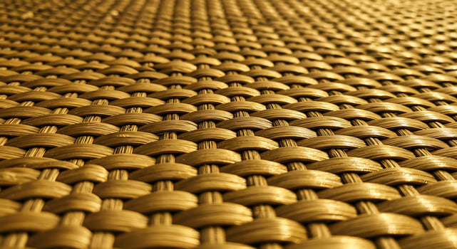 Golden woven texture pattern showcasing intricate craftsmanship and warm tones. photo