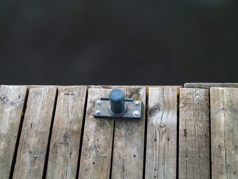 Metal object is sitting on a wooden dock. Zagrze lake, Poland photo