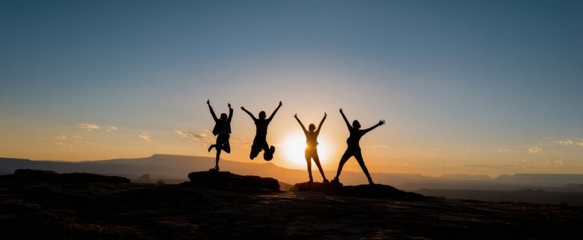 The joyful group celebrating life at sunset in a breathtaking landscape. photo