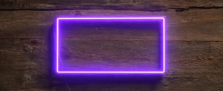 The luminous purple neon frame highlighting a rustic wooden background. photo