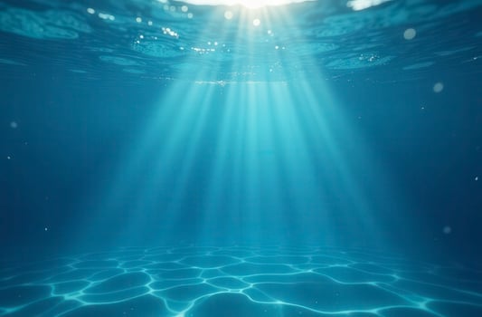 Underwater sunlight illuminating ocean floor with gentle ripples photo