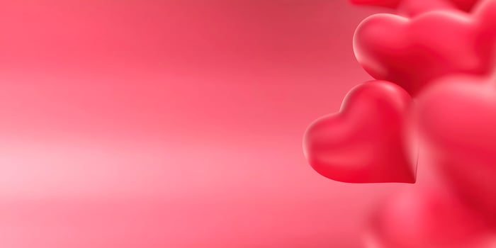 Red hearts floating on a pink background representing love and romance, creating a romantic and affectionate atmosphere photo