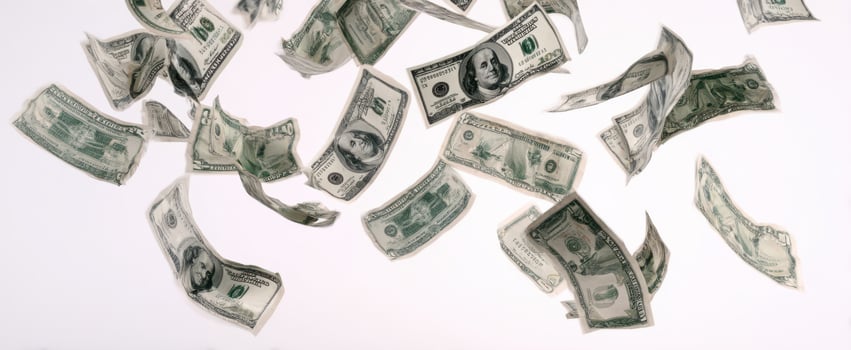 The whirlwind of dollar bills floating in the air against a white background. photo