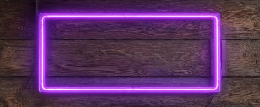 The Bright Purple Neon Frame Against a Rustic Wooden Background. photo