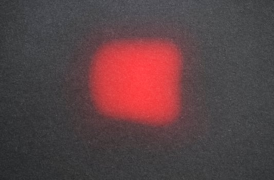 Glowing red shape on dark background photo
