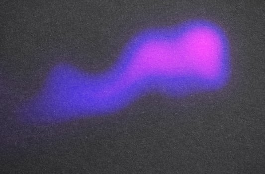 Glowing purple and blue light on dark surface photo