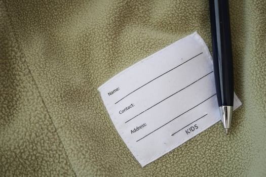 Label on kids' garment with pen on soft fabric surface photo